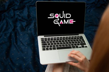 Riga, Latvia - February 24, 2023: Squid Game logo on laptop computer. Squid Game is a popular South Korean survival drama television series available on Netflix.