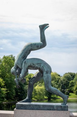 Oslo, Norway - July 12, 2023: Sculpture in Frogner Park, sculpture created by Gustav Vigeland. Public park in capital city of Norway. clipart