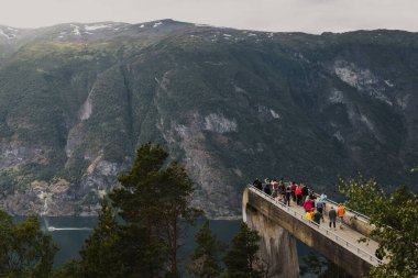 Aurlandsvangen, Norveç - 7 Temmuz 2023: Stegastein platforma bakın. Woodem Köprüsü 'nün inşaatı fiyorda doğru kayalıklardan aşağı atlıyor. Norveç dağlarının yüksek görüş açısı.