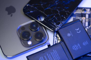 South Tyrol, Italy - Jan. 7. 2023: Broken iPhone display on top of new iPhone model. Replacement parts for Smartphone