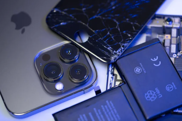 South Tyrol, Italy - Jan. 7. 2023: Broken iPhone display on top of new iPhone model. Replacement parts for Smartphone