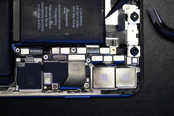 South Tyrol, Italy - Jan. 7. 2023: Replacing iPhone battery. Fix broken Smartphone. Right to repair Smartphone