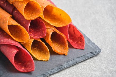 Fruit and berry pastille, dessert with nuts and seeds slate board