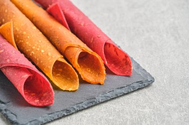 Fruit and berry pastille, dessert with nuts and seeds slate board
