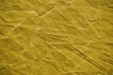 Abstract yellow gold background crumpled fabric