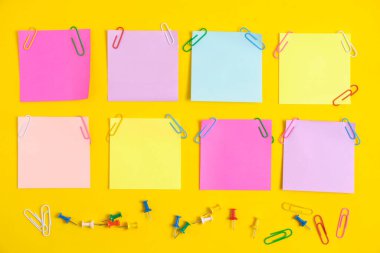 Colorful stickers for notes and stationery buttons with paper clips yellow background