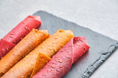 Fruit and berry pastille, dessert with nuts and seeds slate board