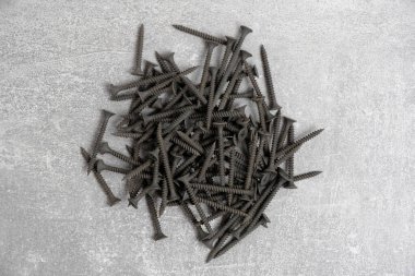 Bunch black wood screws gray background