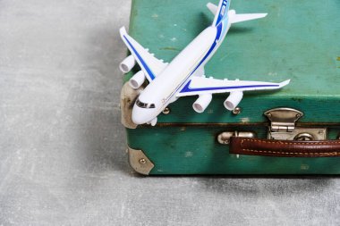 Old vintage, retro suitcase and toy airplane.Concept vacation and travel