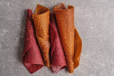 Fruit and berry pastille, dessert with nuts and seeds on a light background