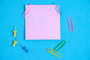 Lilac paper stickers for writing notes on a blue background