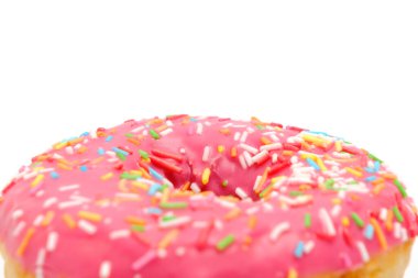 Donut with pink icing and multicolored sugar sprinkles.On white background,closeup