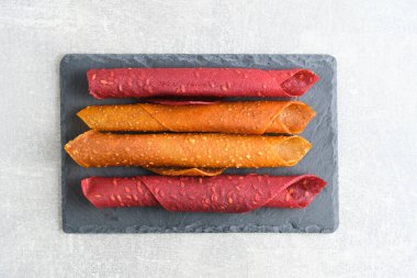 Fruit and berry pastille, dessert with nuts and seeds slate board