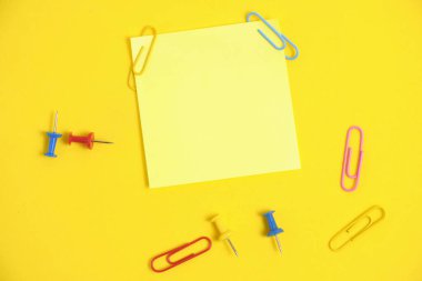 Yellow sticker for notes and stationery buttons with paper clips yellow background