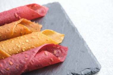 Fruit and berry pastille, dessert with nuts and seeds slate board