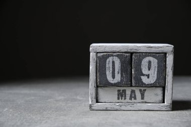 May 9 calendar made wooden cubes gray background.With an empty space for your text
