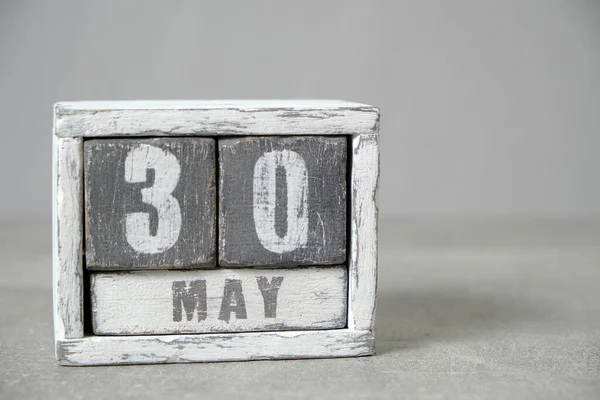 May 30 calendar made wooden cubes gray background.With an empty space for your text