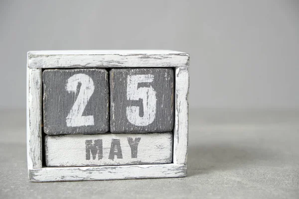 May 25 calendar made wooden cubes gray background.With an empty space for your text