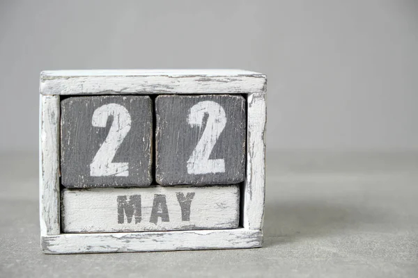 May 22 calendar made wooden cubes gray background.With an empty space for your text