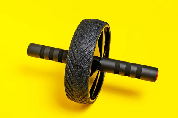 Sports simulator roller for press on yellow background