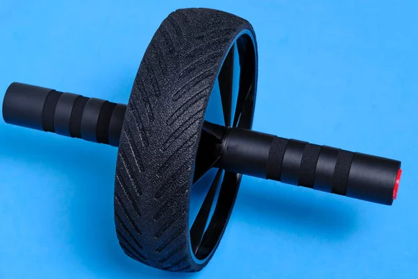 Sports simulator roller for press on blue background