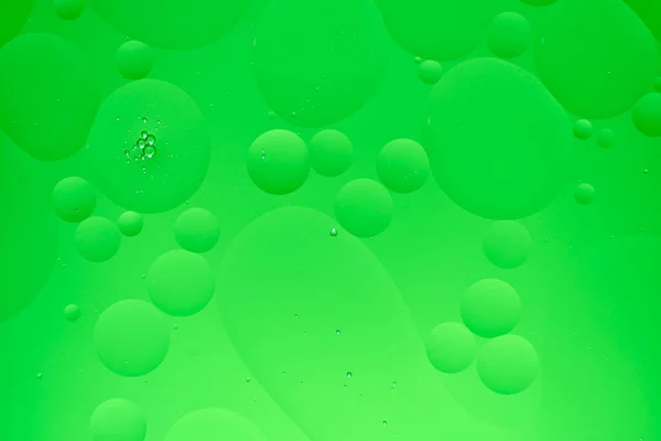 Abstract background with green oil circles and gradient.