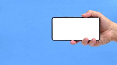 El mavisi arka plan temiz beyaz ekranlı akıllı telefonu tutar