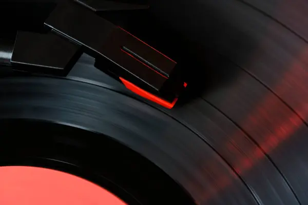 Black vinyl record and needle for playing music from vinyl top view