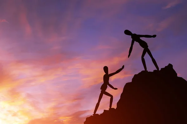 Two silhouettes mannequin climb mountain, one helping other, extending helping hand. Against background sky, sunset and clouds. Concept of help and success in teamwork