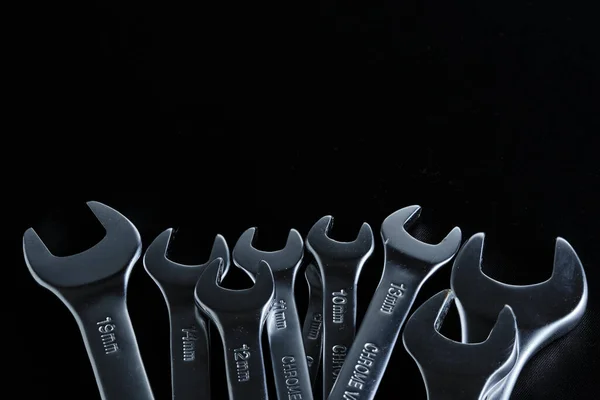 Set of wrenches black background. Mechanics and industry.