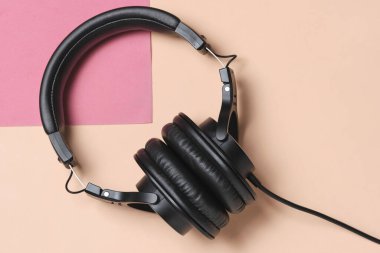 Siyah kulaklıklar bej pembe arka plan