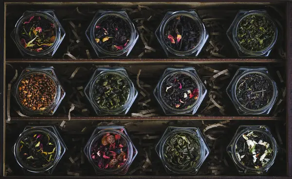 Set of various leaf tea packaged in jars. Black and green healthy tea with fruits, berries and herbs