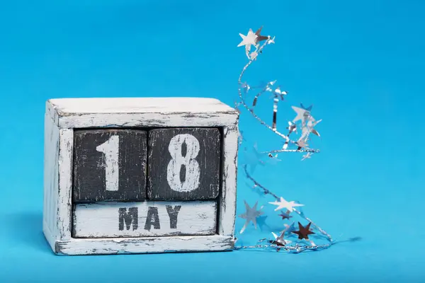 May 18 on calendar lying on blue background. Spring Astronomy Day