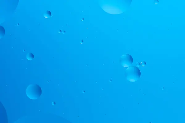 stock image Serene abstract image with various sized blue bubbles light blue background, creating minimalistic and calming visual