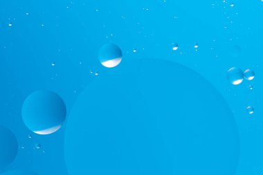 Açık mavi arkaplanda süzülen mavi kabarcıklar barışçıl ve minimalist bir soyut tasarım oluşturur