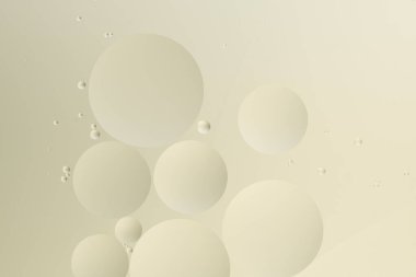 Bej arka planda çeşitli boyutlarda çemberler, soyut bir model oluşturuyor. Görüntü sakin ve minimalist