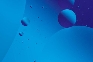 Mavi ve mor baloncuklu sakin ve minimalist tasarım koyu mavi arka planda farklı boyutlarda.