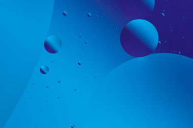 Mavi ve mor baloncuklu sakin ve minimalist tasarım koyu mavi arka planda farklı boyutlarda.