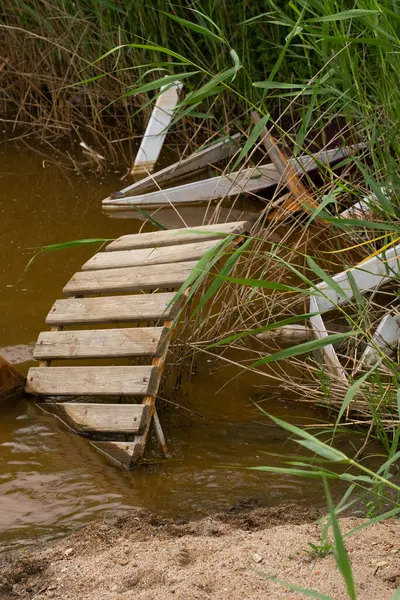 stock image Polluted river and beach with construction debris and waste. Environmental pollution