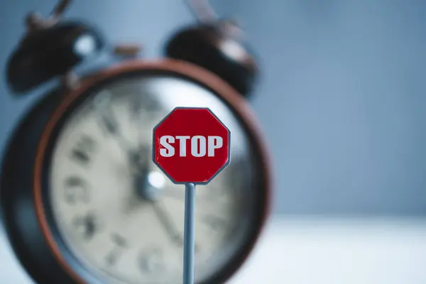 stock image Stop sign and alarm clock on blue background. Stop time concept