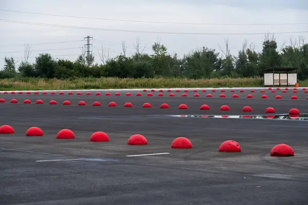 stock image Empty parking lot with red traffic cones in rural area in summer