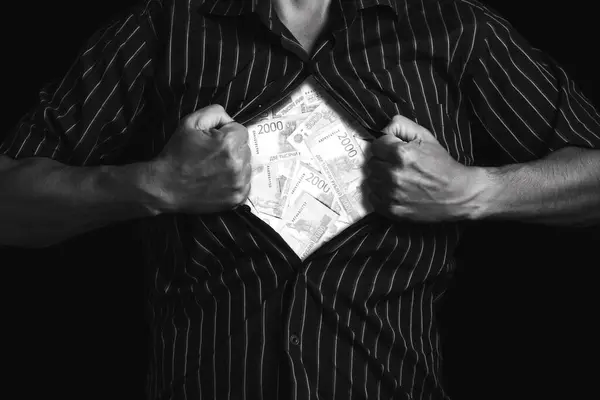 stock image Businessman tears his shirt and shows ruble banknotes. Black and white