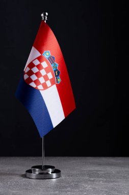 Hırvatistan bayrağını siyah arka planda metal bayrak direğine dikti. Metin için yer