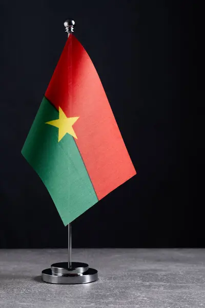 stock image Flag of Burkina Faso on small flagpole on black background