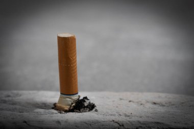 Cigarette butt on a concrete background. Selective focus