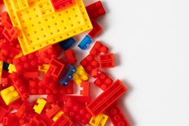 Plastic building blocks on white background. Top view. Copy space clipart