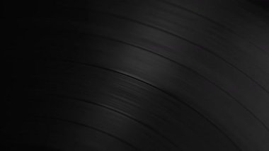 Arkaplan, dönen siyah vinil plak içinde ışık yansıması..