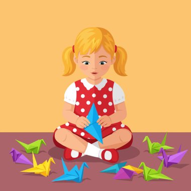 Genç bir kız elinde mavi bir origami vinç tutarken konsantre oluyor. Yerde bir kaç renkli kuş var. Çocukluk aktiviteleri için ideal..