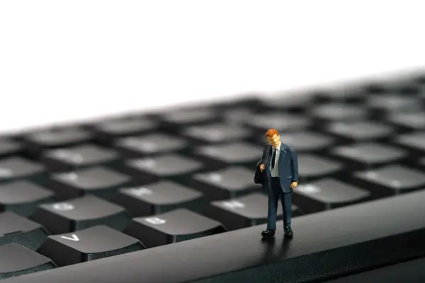 stock image Miniature people toy figure photography. Tired of working overtime concept. A businessman standing above keyboard. Image photo