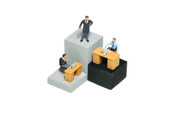 Miniature tiny people toy figure photography. Organization hierarchy and work monitoring illustration concept. A businessman and businesswoman working on different level at tower building. Image photo